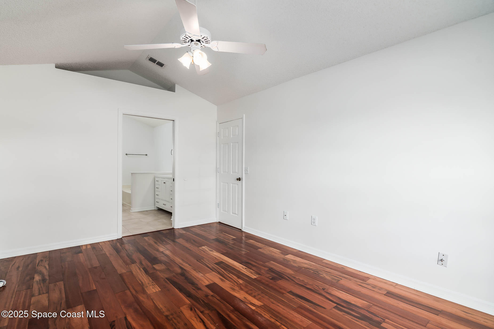 6760 Cairo Road Cocoa, FL 32927 - Photo 37 of 51 a view of a room with wooden floor and a ceiling fan