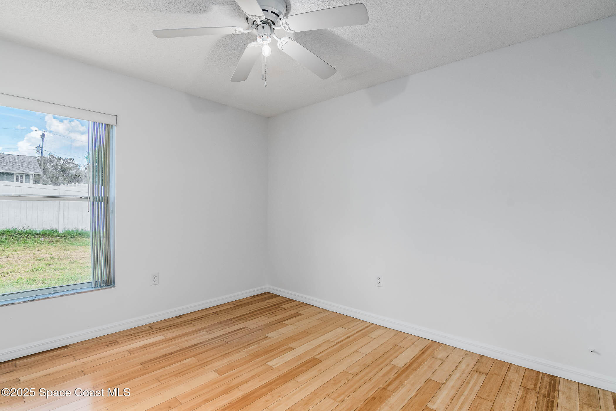6760 Cairo Road Cocoa, FL 32927 - Photo 42 of 51 wooden floor in an empty room with a window