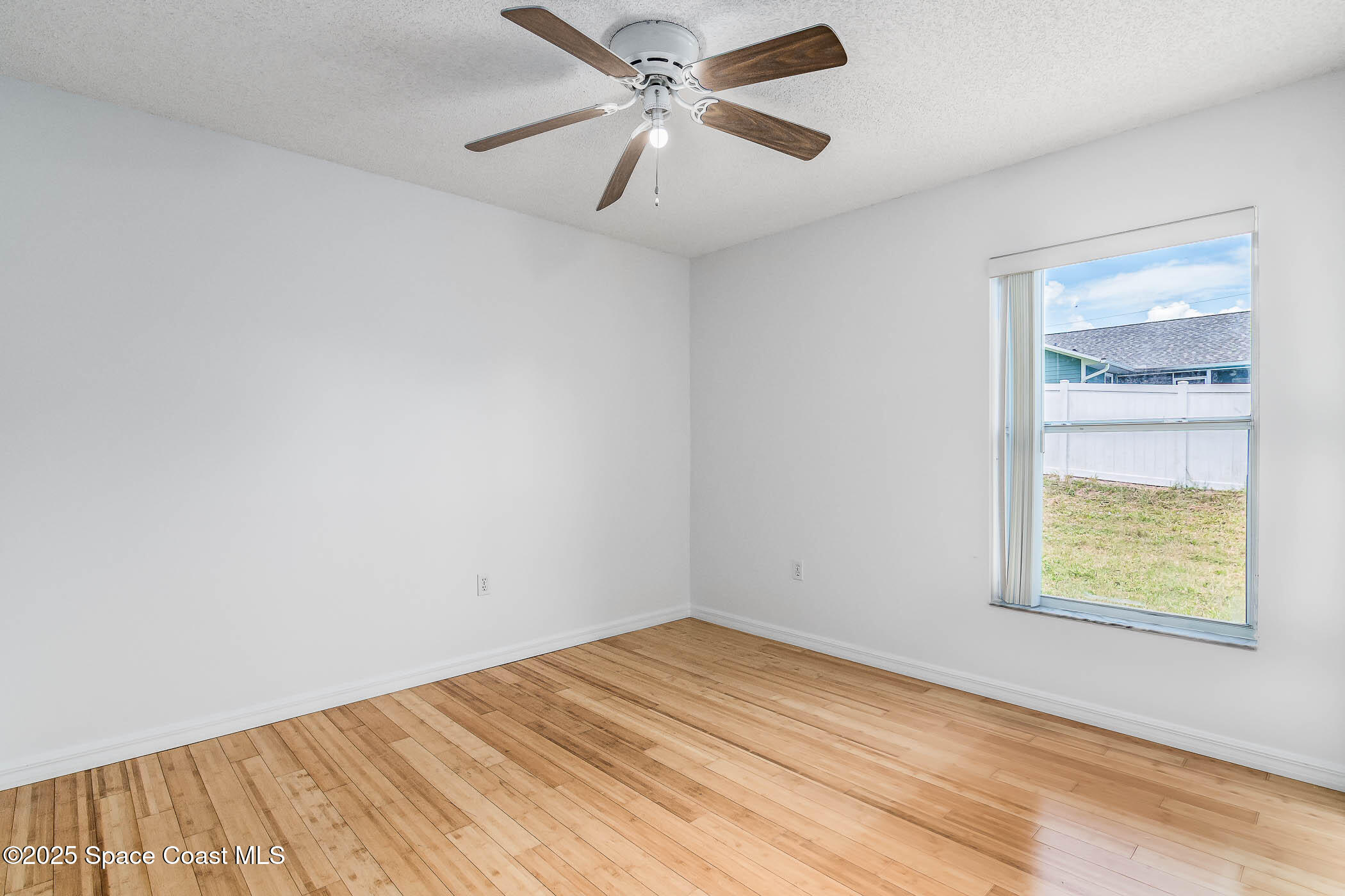 6760 Cairo Road Cocoa, FL 32927 - Photo 44 of 51 an empty room with a window and a fan