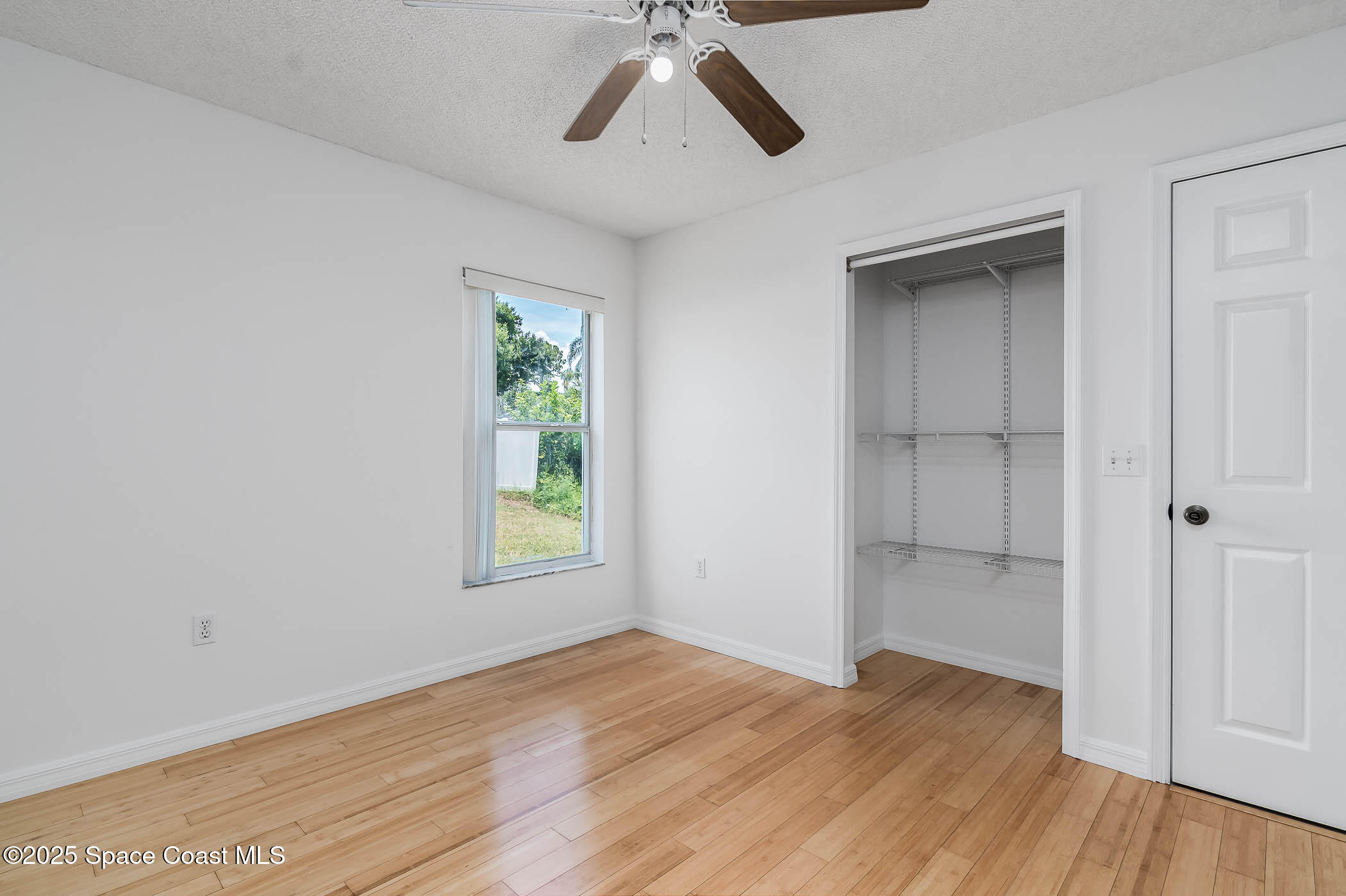6760 Cairo Road Cocoa, FL 32927 - Photo 45 of 51 a view of empty room with wooden floor and ceiling fan