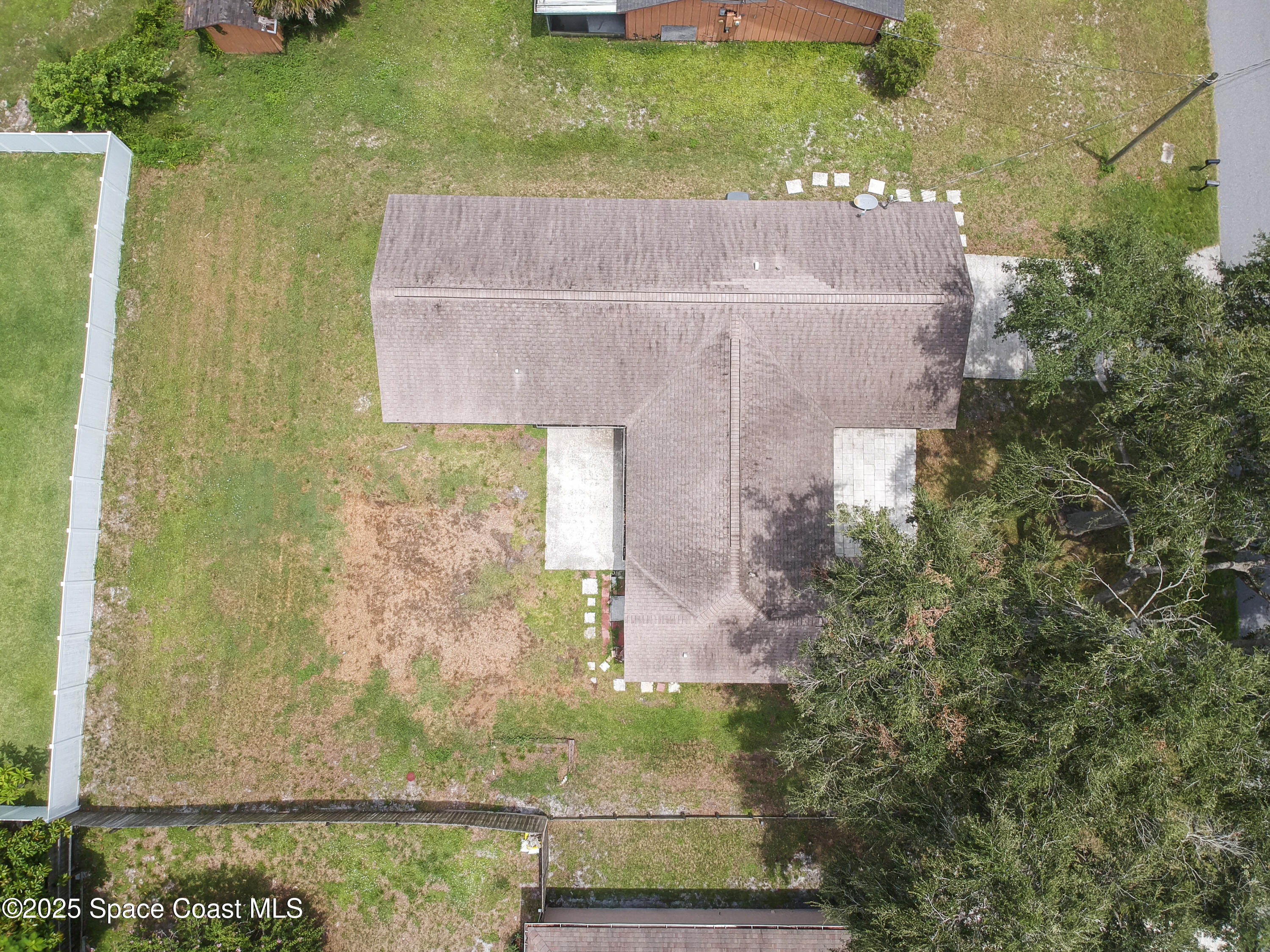 6760 Cairo Road Cocoa, FL 32927 - Photo 47 of 51 an aerial view of a house with a yard and a large tree