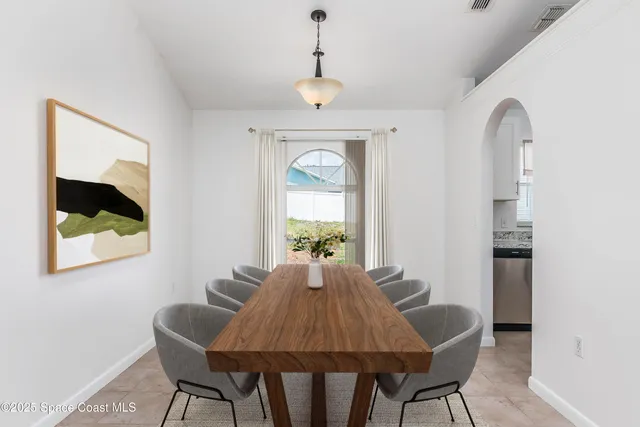 a dining room with furniture and window