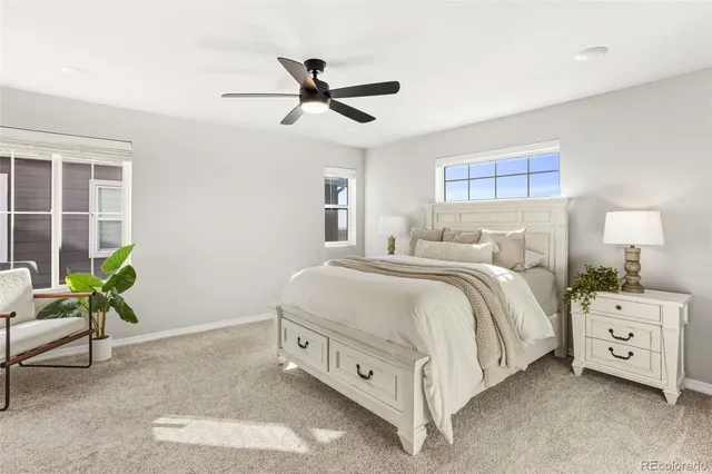 a spacious bedroom with a bed and a window