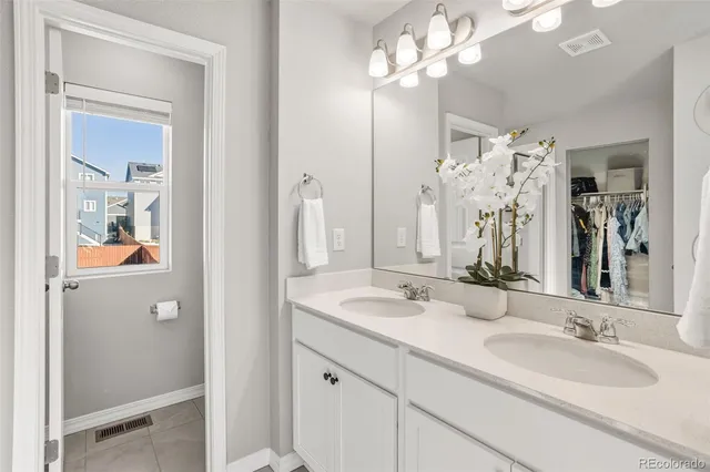 a bathroom with a granite countertop sink a mirror and a shower