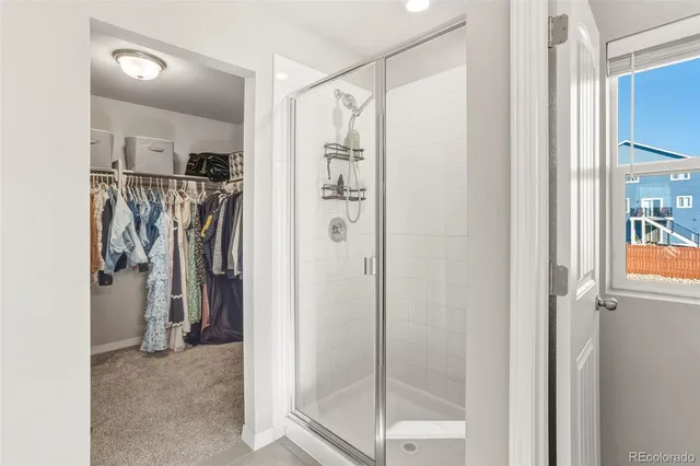 a view of a walk in closet and bathroom