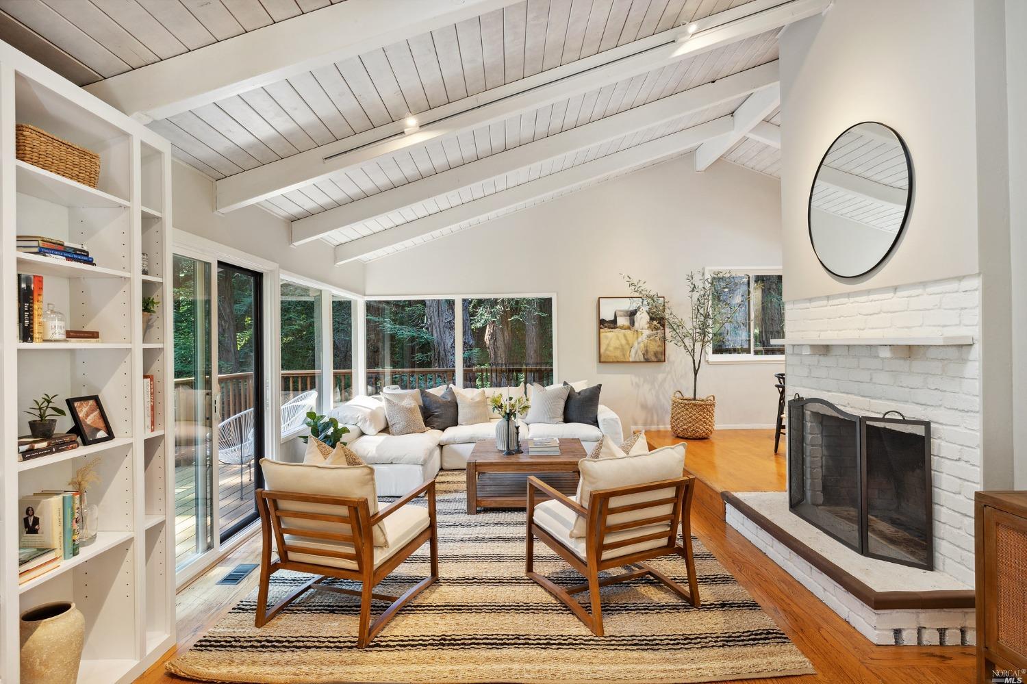 a living room with furniture a fireplace and a large window