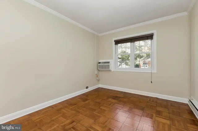 an empty room with closet and a bathroom