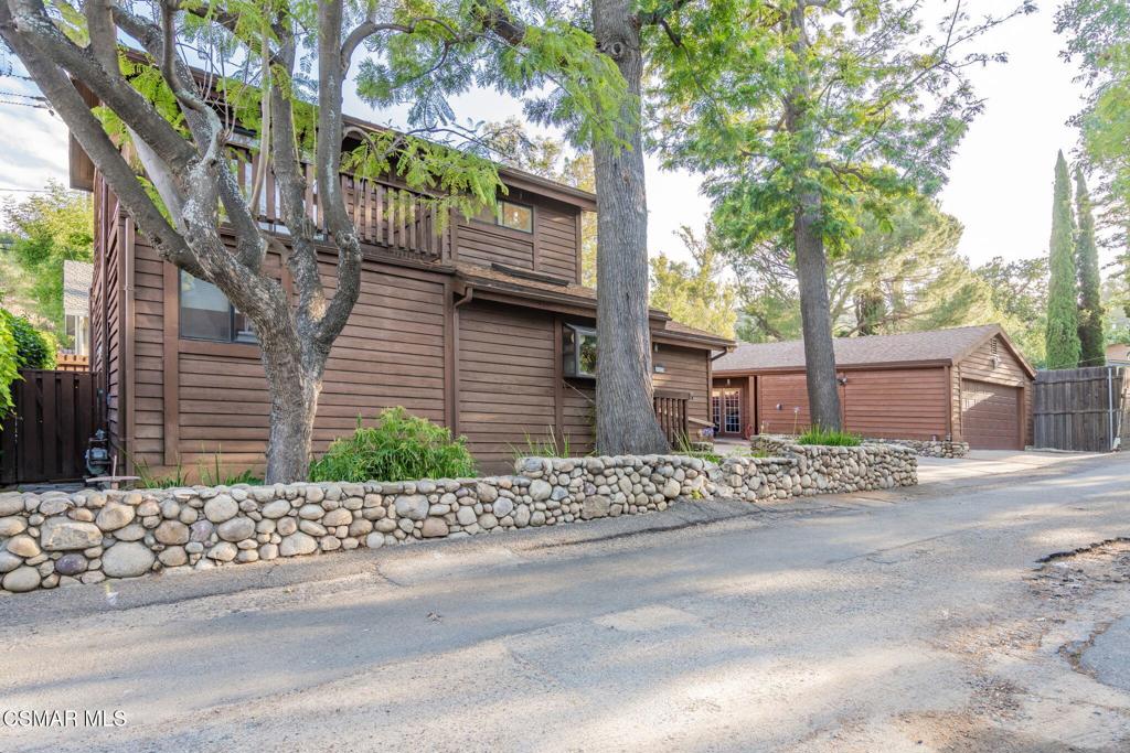 6078 Peppertree Lane Simi Valley, CA 93063 - Photo 6 of 59 a wooden house with tree in front of it