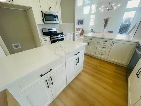 a kitchen with stainless steel appliances granite countertop a stove and a microwave