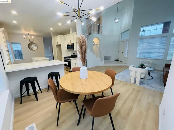 a kitchen with a table chairs and a dining table