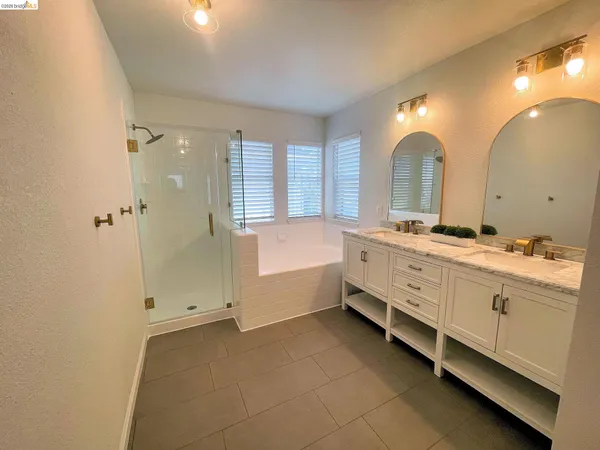 a bathroom with a window and a shower