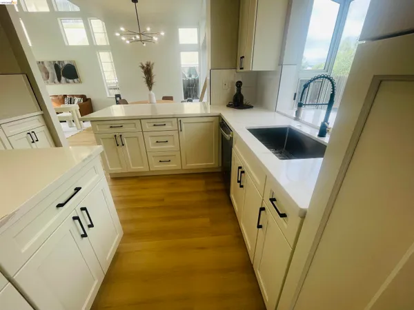 a kitchen with stainless steel appliances white cabinets and a refrigerator