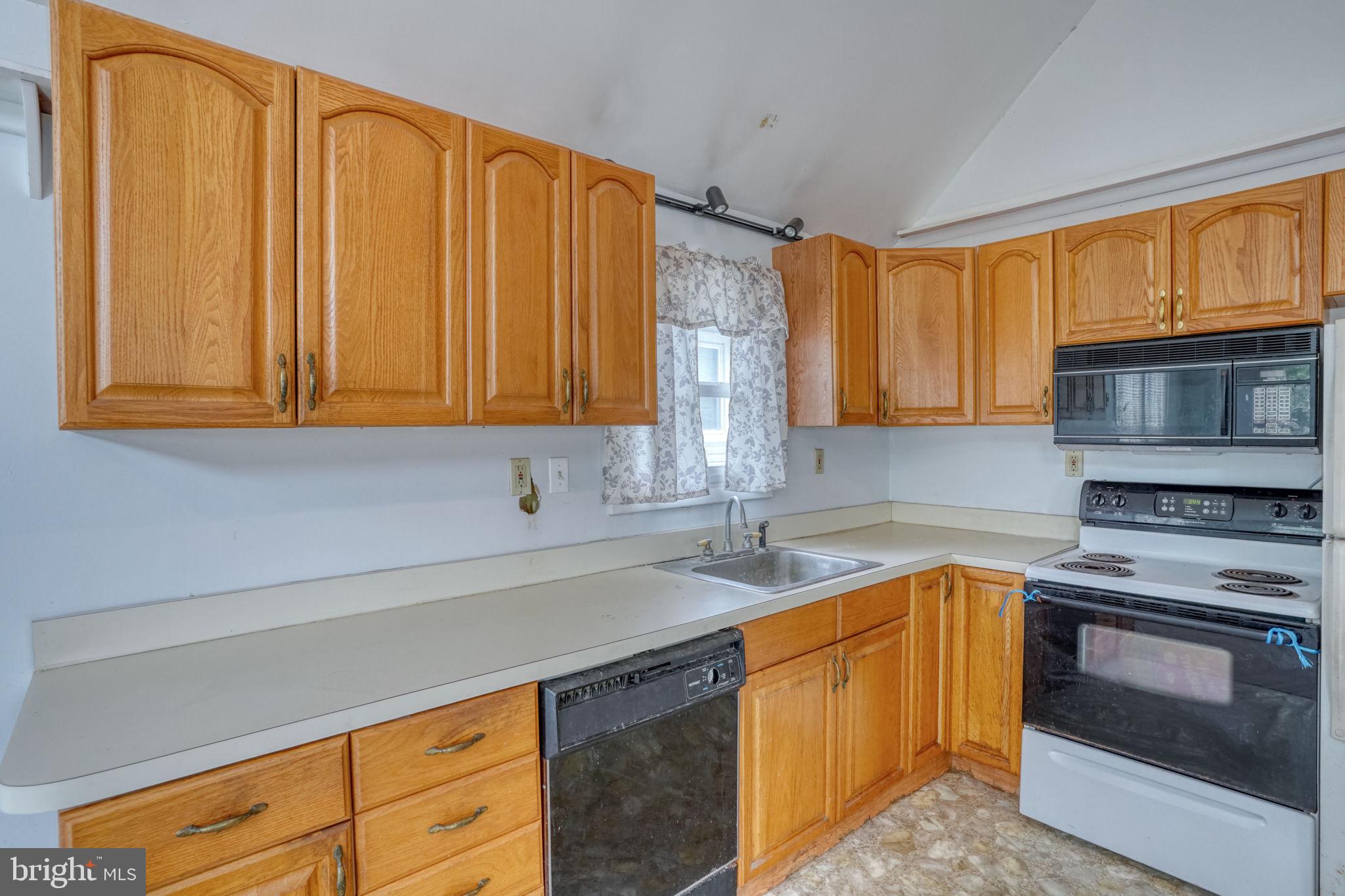 257 Front Street Leipsic, DE 19901 - Photo 16 of 37 a kitchen with a sink stove and microwave