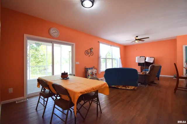 a dining room with furniture and wooden floor