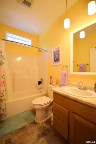 a bathroom with a sink toilet a mirror and shower