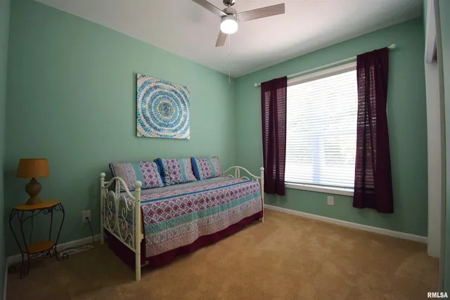 a bed room with a bed and a window