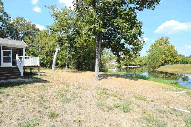 a view of backyard of house with green space