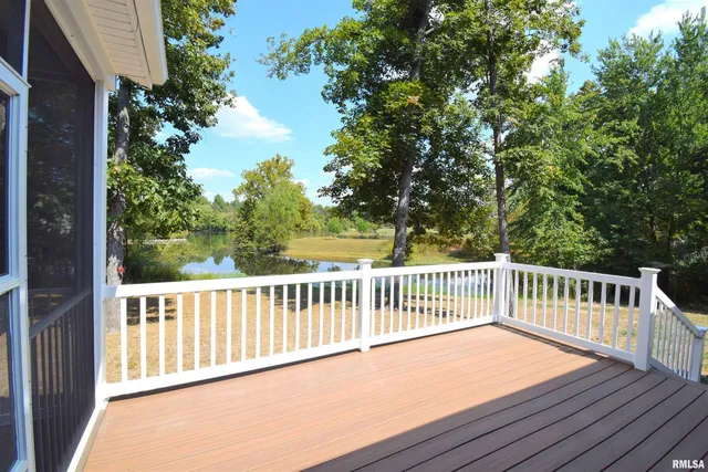 a balcony with wooden floor and fence