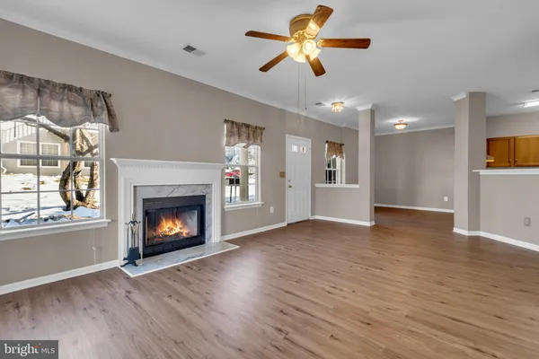 a view of an empty room with a fireplace and a window