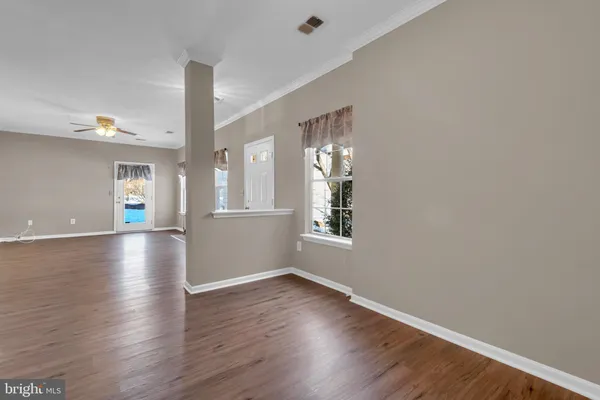 wooden floor in an empty room with a window