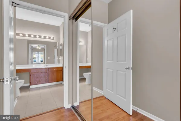 a bathroom with a glass shower door and a mirror