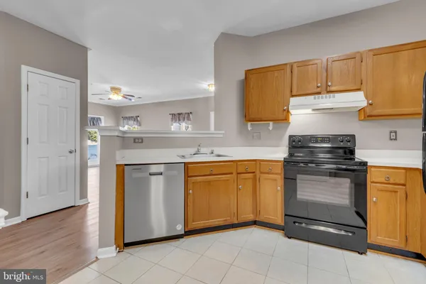 a kitchen with stainless steel appliances granite countertop a stove and a sink