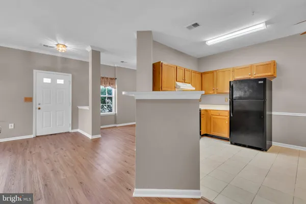 a view of a kitchen with a sink and a refrigerator