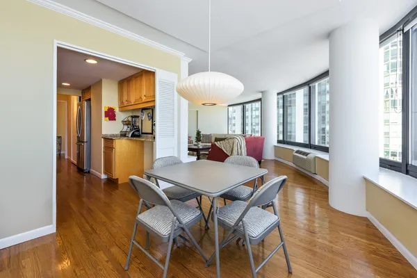 a view of a dining room with furniture and a chandelier