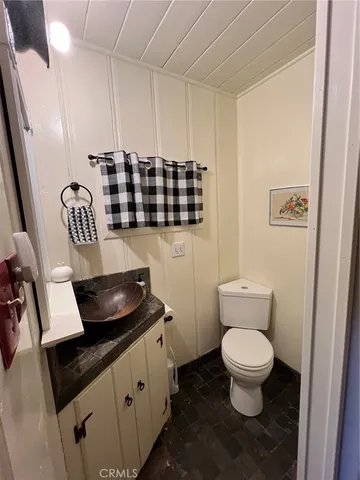 a kitchen with a sink a toilet and a mirror