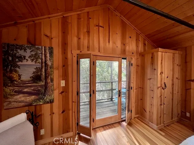 a view of a back yard from a wooden door