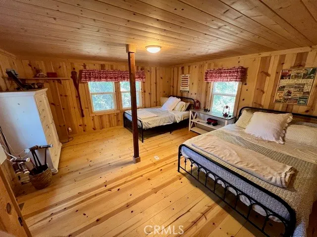 a bedroom with furniture and a wooden floor