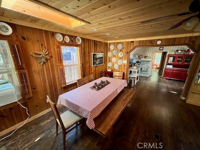 a dining room with furniture and a flat screen tv
