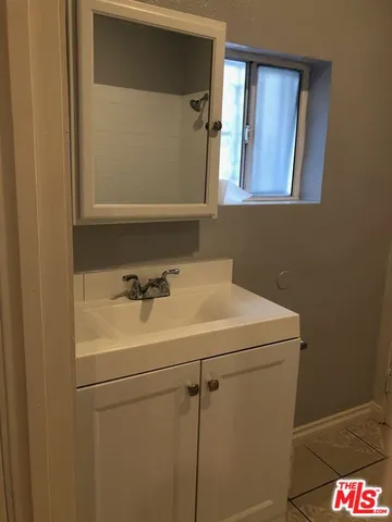 a bathroom with a sink and mirror