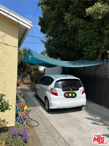 a car parked in front of white house