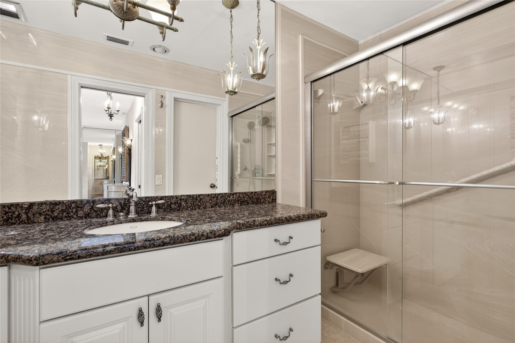 1001 North Riverside Drive, Unit 305 Pompano Beach, FL 33062 - Photo 22 of 44 a bathroom with a granite countertop sink a mirror and a shower
