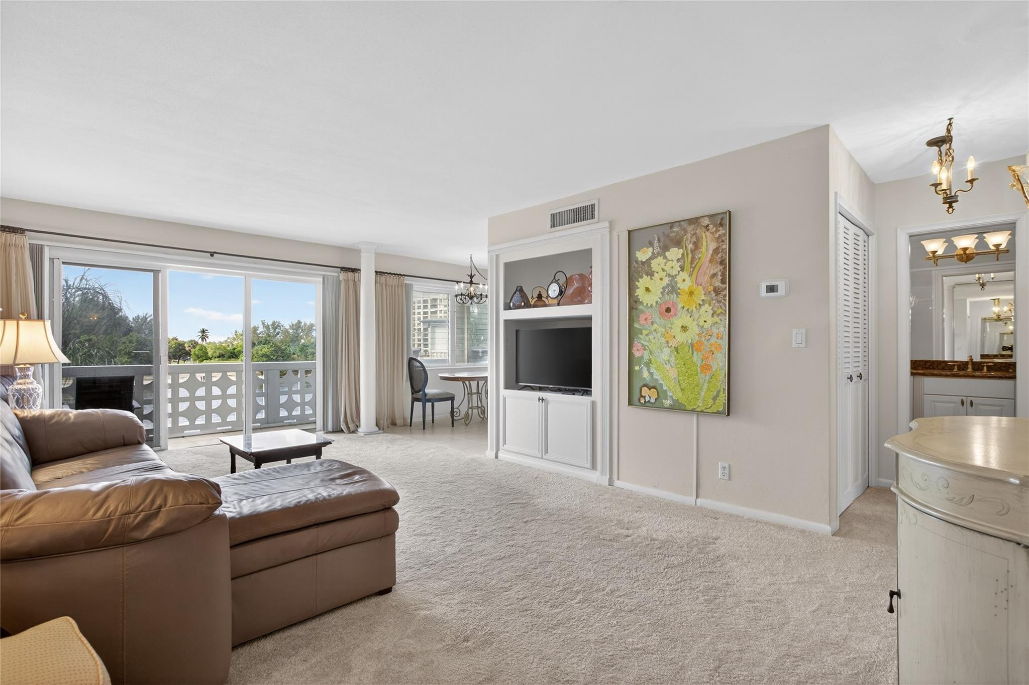 1001 North Riverside Drive, Unit 305 Pompano Beach, FL 33062 - Photo 10 of 44 a living room with furniture and a flat screen tv