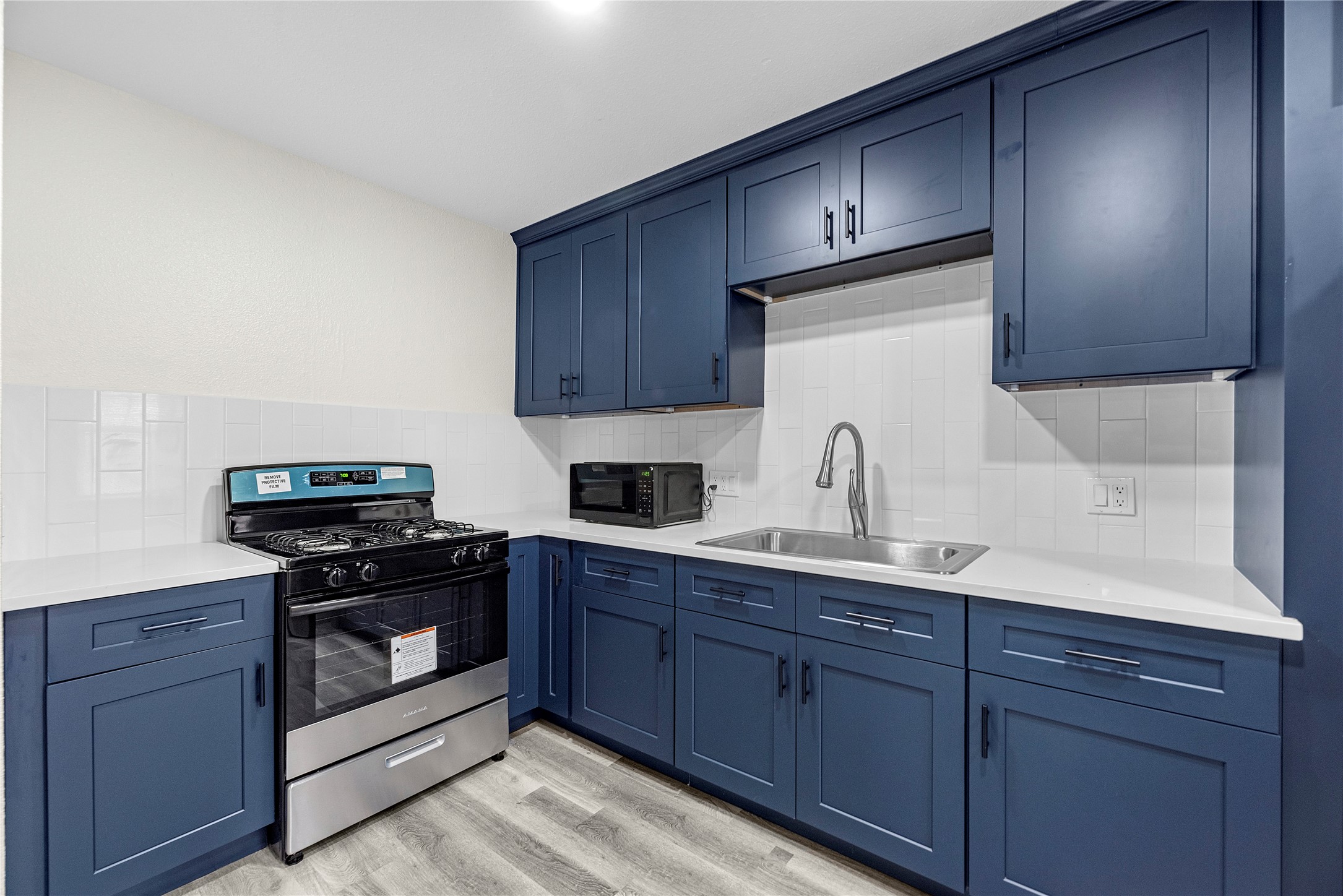 7614 Grahamcrest Drive, Unit 2 Houston, TX 77061 - Photo 3 of 9 a kitchen with sink a stove and cabinets