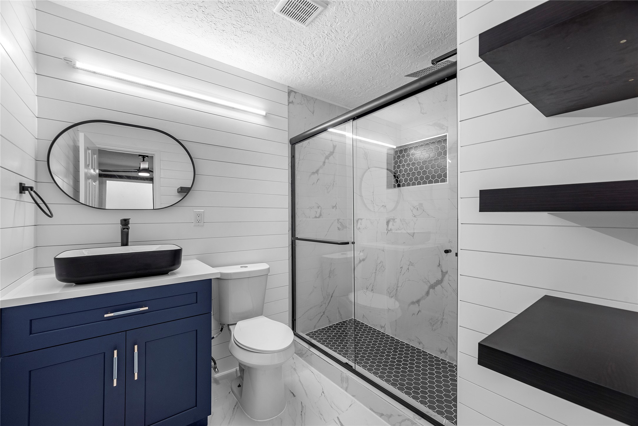 7614 Grahamcrest Drive, Unit 2 Houston, TX 77061 - Photo 5 of 9 a bathroom with a toilet a sink and mirror