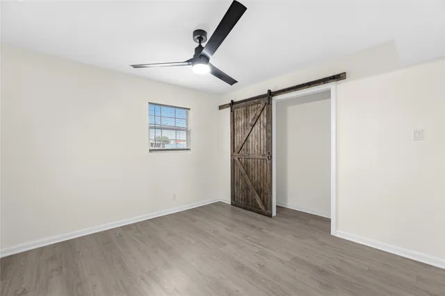 a view of empty room with wooden floor