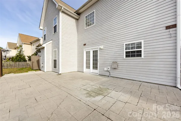 a backyard of a house with table and chairs