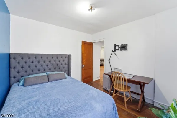 a bedroom with a bed and a chair