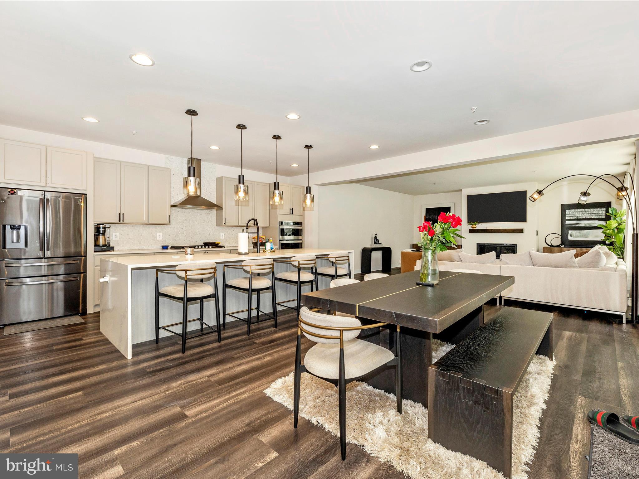 11147 Hazelnut Lane Monrovia, MD 21770 - Photo 11 of 66 a kitchen with stainless steel appliances kitchen island granite countertop a table chairs and a refrigerator