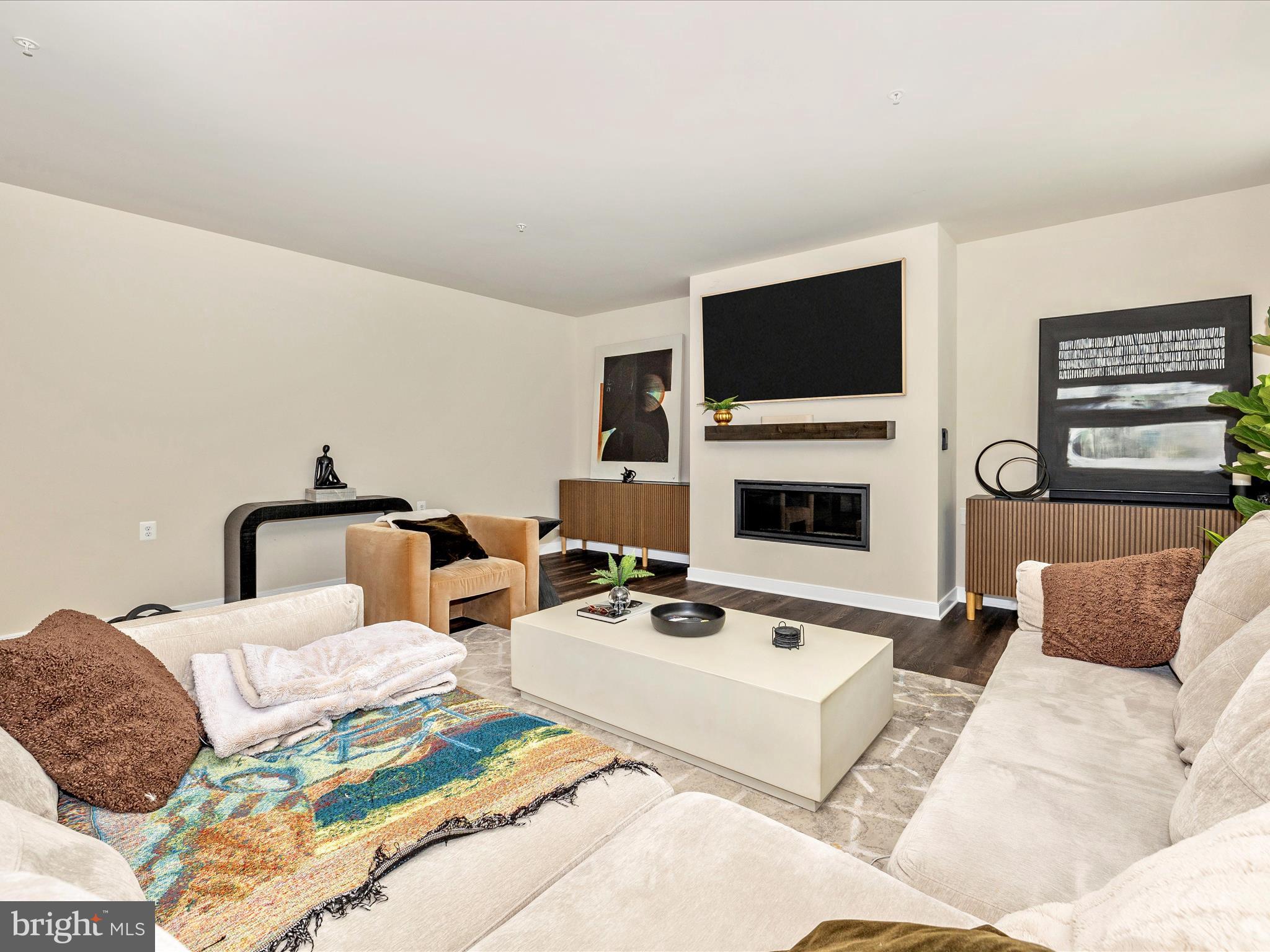 11147 Hazelnut Lane Monrovia, MD 21770 - Photo 16 of 66 a living room with furniture a flat screen tv and a fireplace