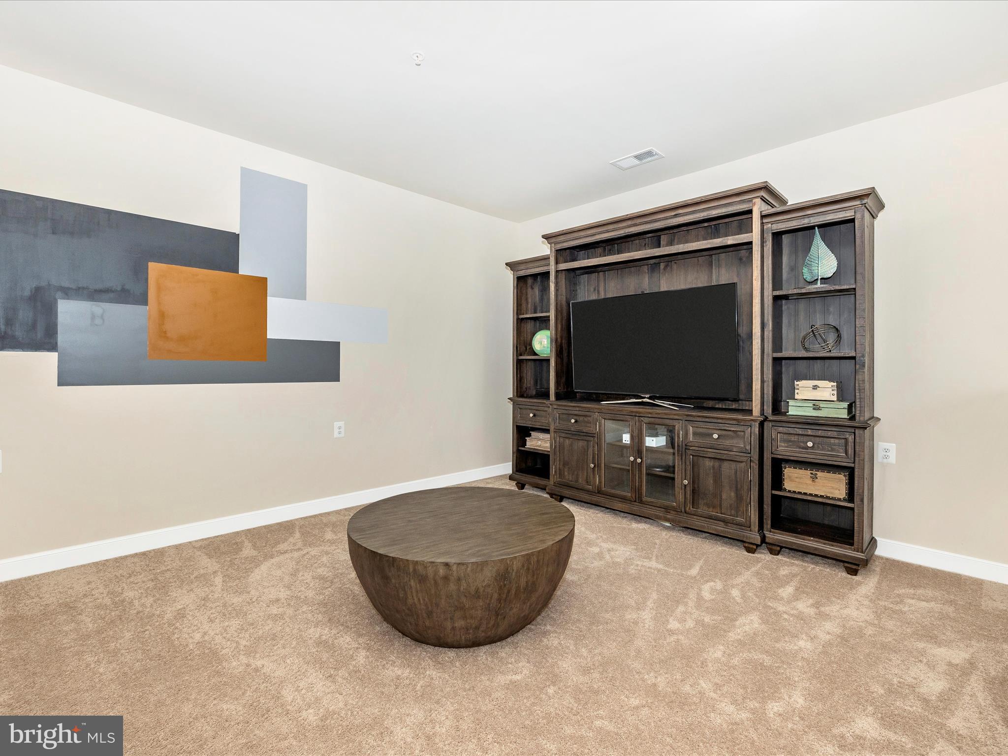 11147 Hazelnut Lane Monrovia, MD 21770 - Photo 19 of 66 a living room with furniture and a flat screen tv
