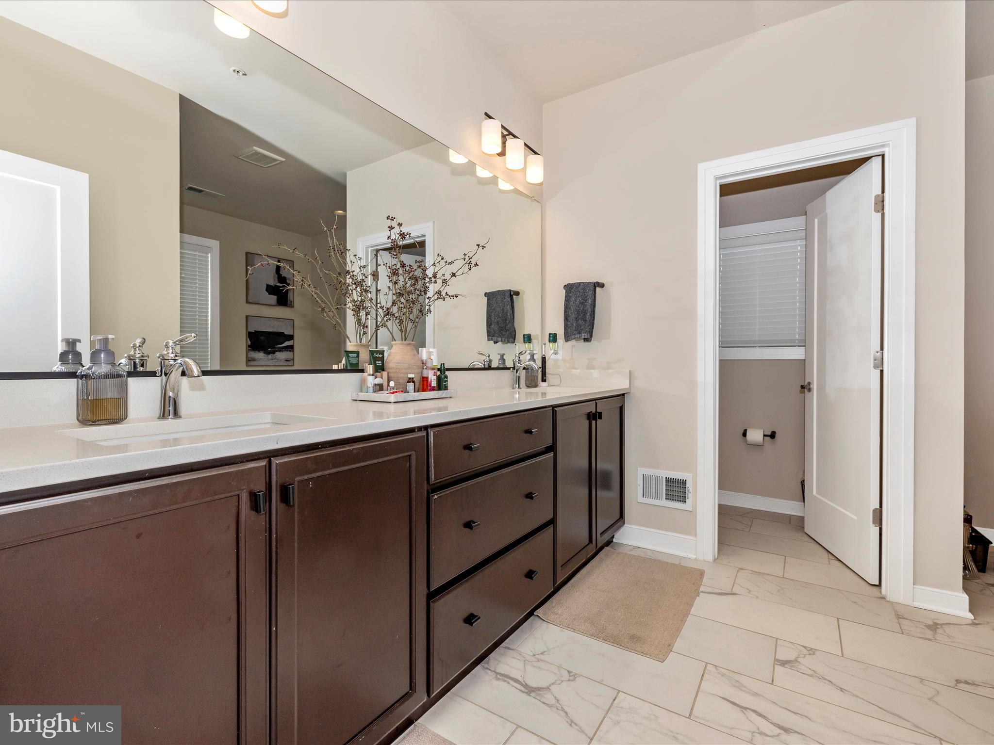 11147 Hazelnut Lane Monrovia, MD 21770 - Photo 24 of 66 a spacious bathroom with a double vanity sink a mirror and a