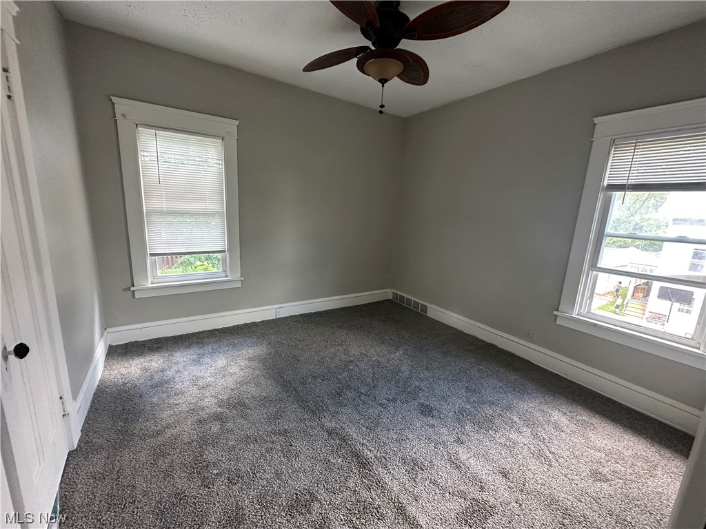 10820 Bellaire Road Cleveland, OH 44111 - Photo 11 of 24 Empty room featuring dark carpet and ceiling fan