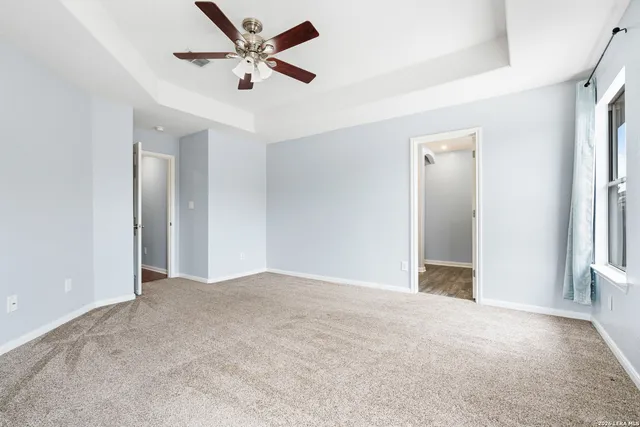 a view of an empty room with a ceiling fan