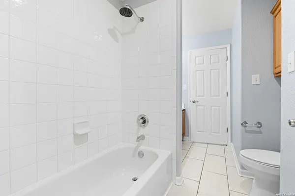 a bathroom with a bathtub and a toilet