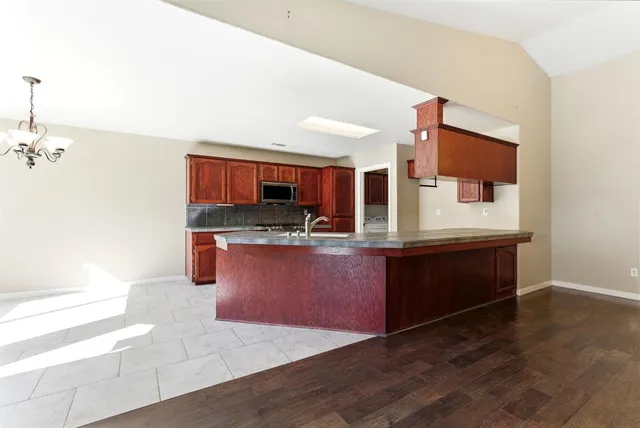 a kitchen with stainless steel appliances granite countertop a stove and a sink