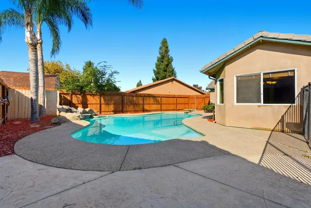 a house with swimming pool in front of it
